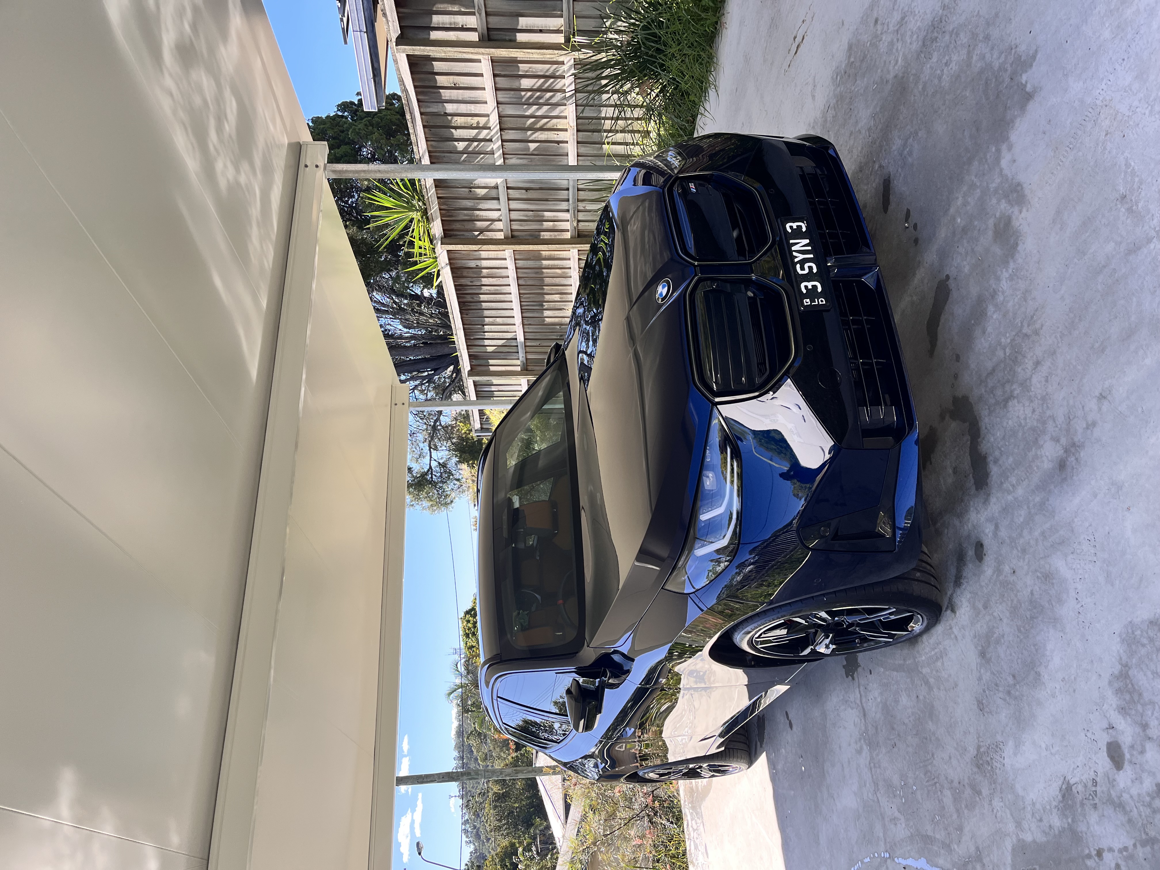 Freshly detailed BMW X3 under a carport — mobile car detailing Brisbane