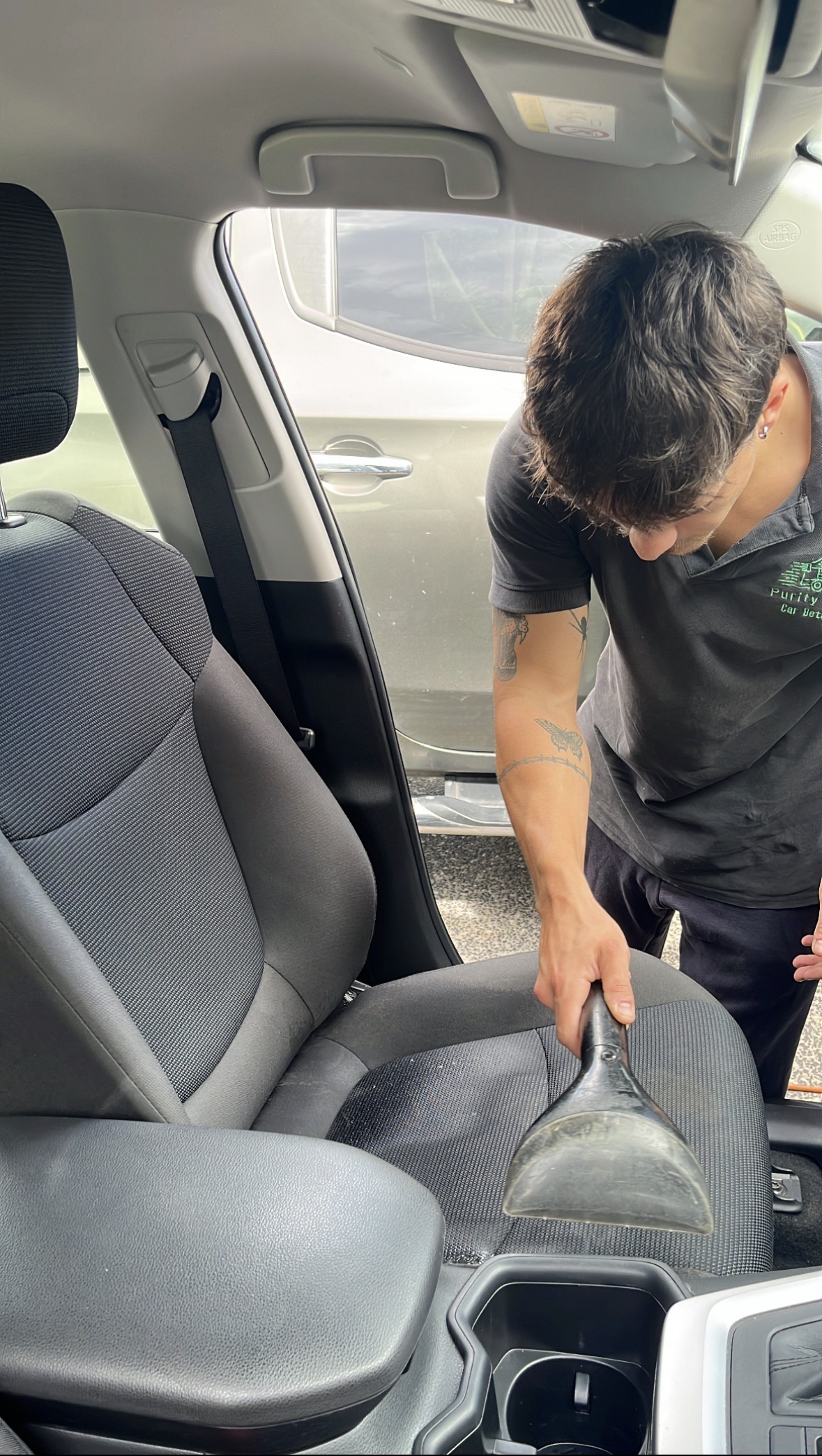 Purity Wash detailer steam-extracting car seats at a Brisbane home